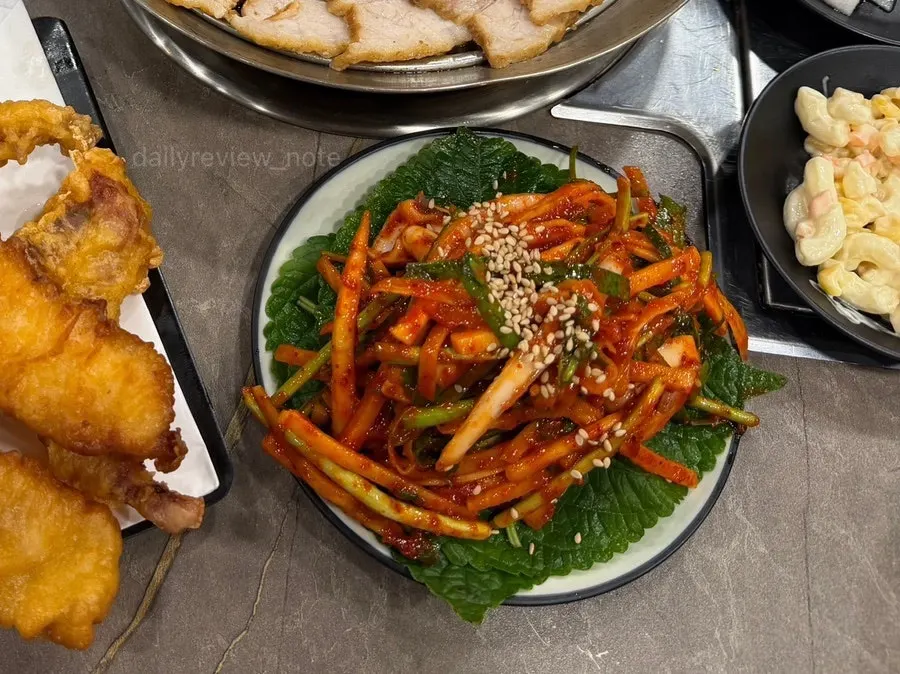White kimchi served alongside the boiled pork