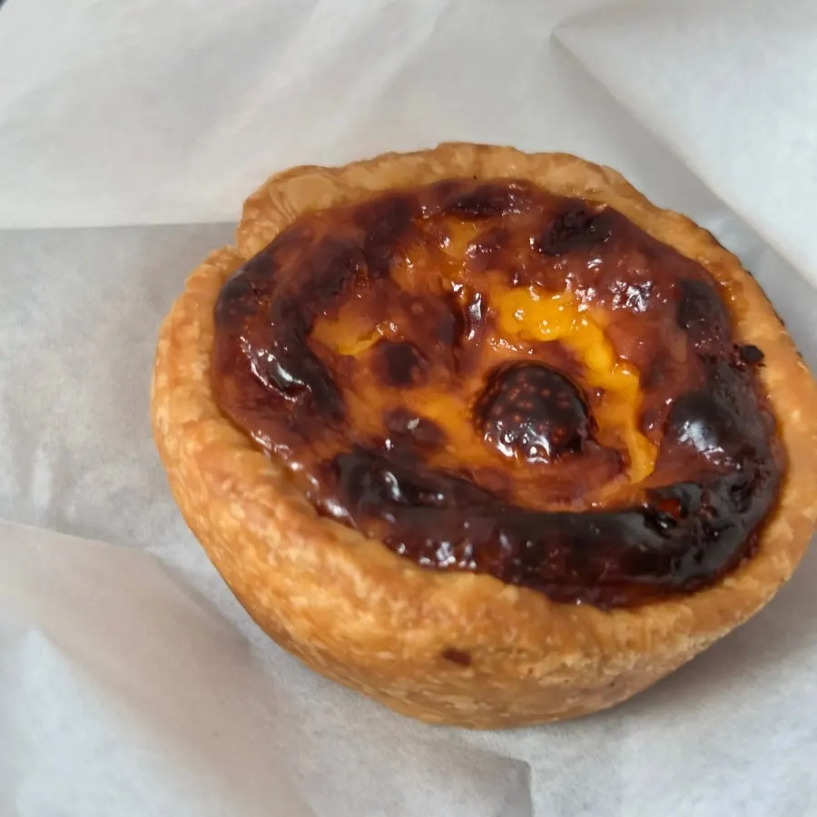 Egg tart with visible flaky pastry layers