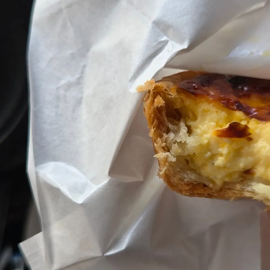 Cross-section of an egg tart showing the moist filling