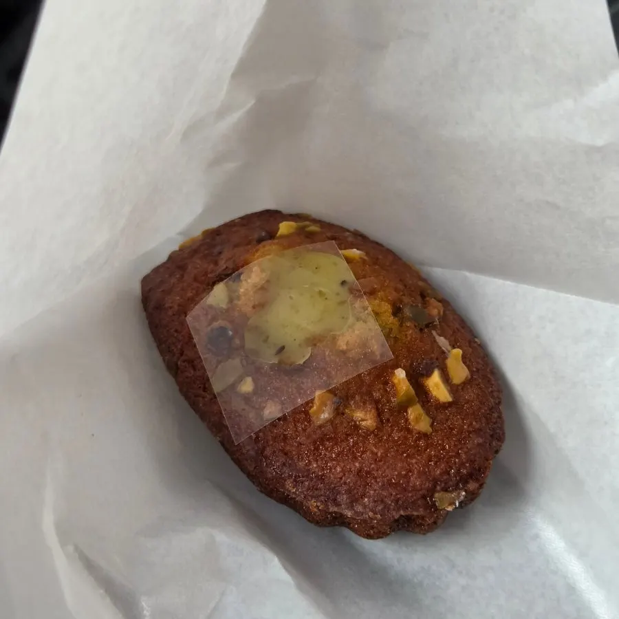 Moist crumb texture inside a pistachio madeleine