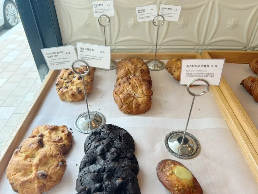 Bakery display case with cookies and madeleines