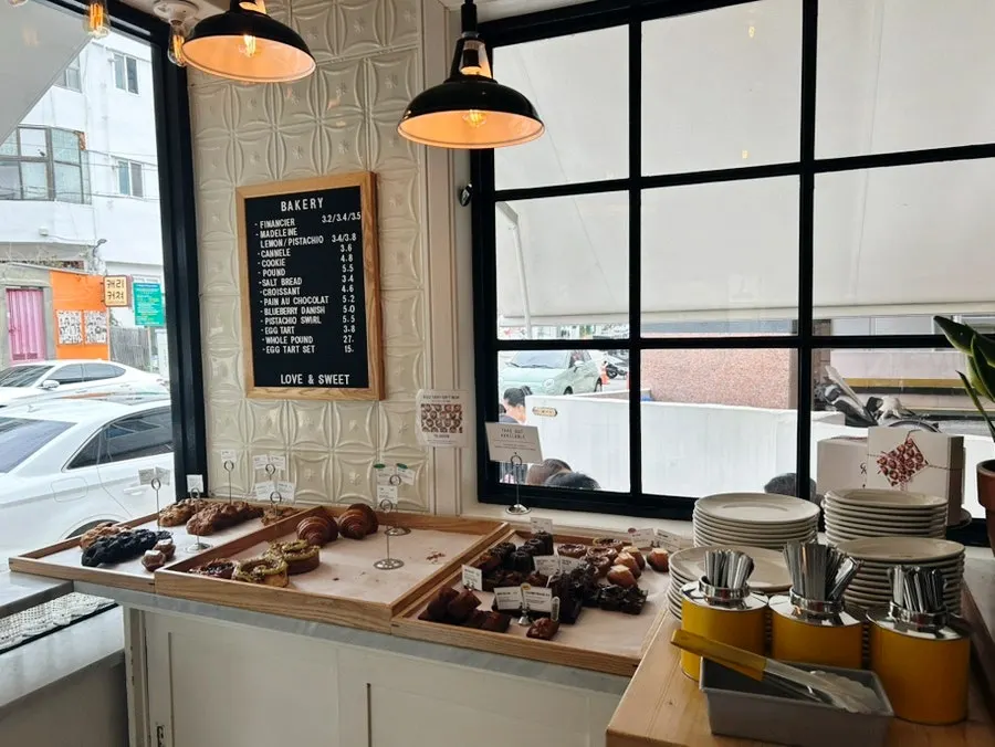 Display case with egg tarts and canelés