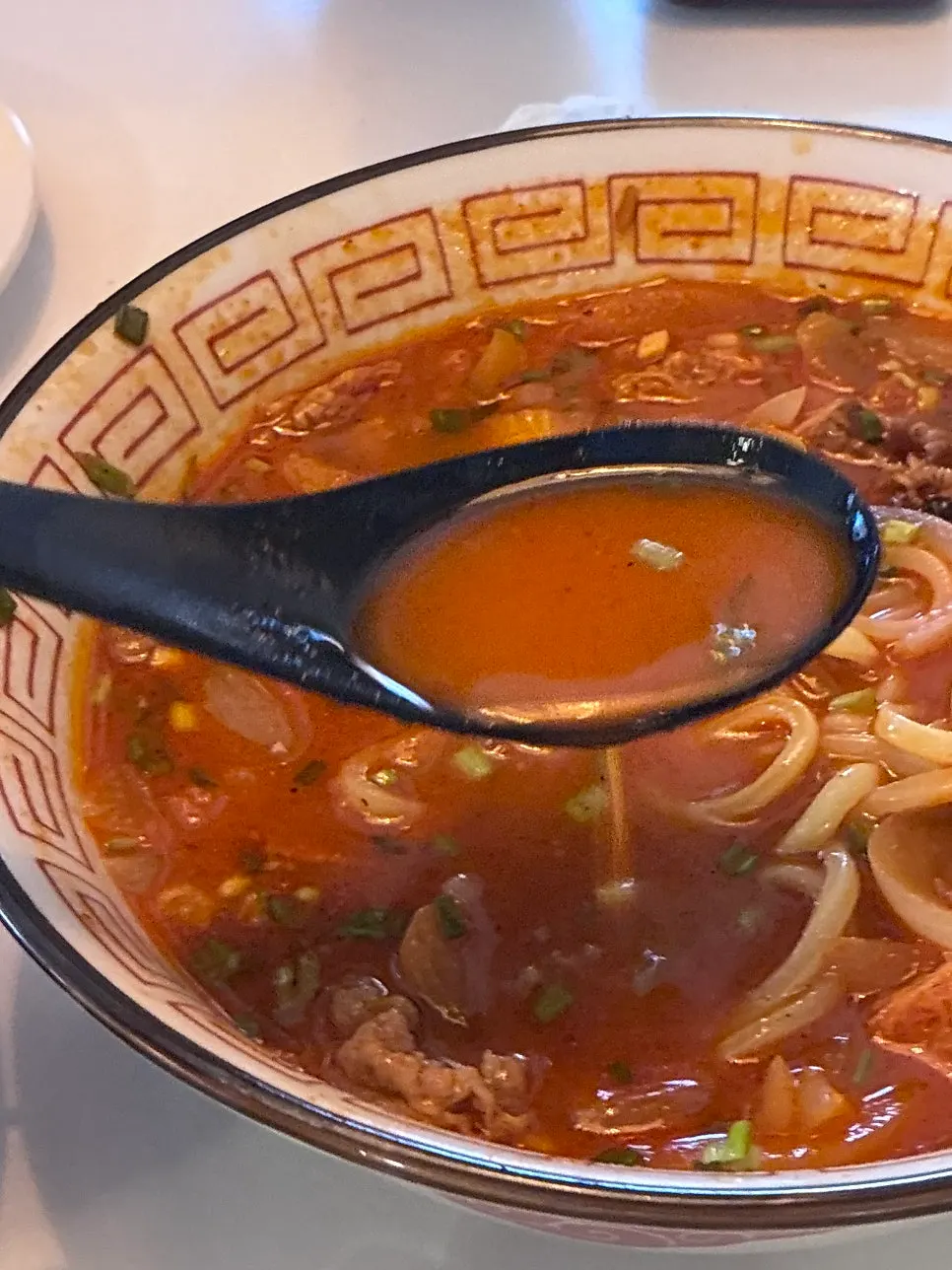 Lifting a bite of jjamppong noodles