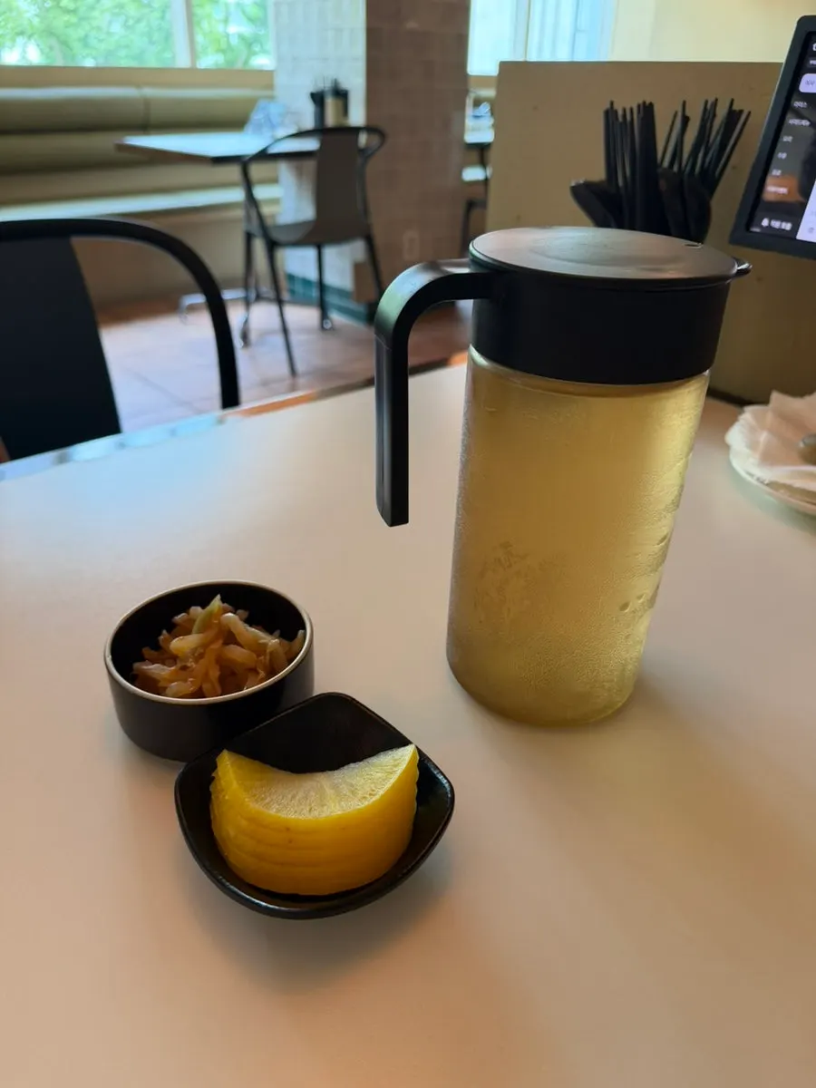 Complimentary tea, pickled radish, and pickled mustard greens