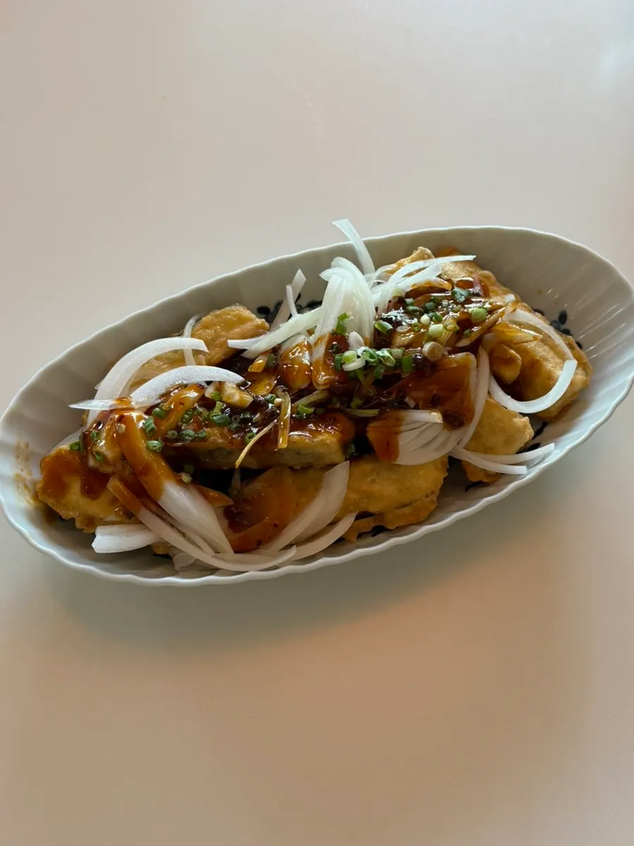 Plate of yuxiang eggplant topped with sauce