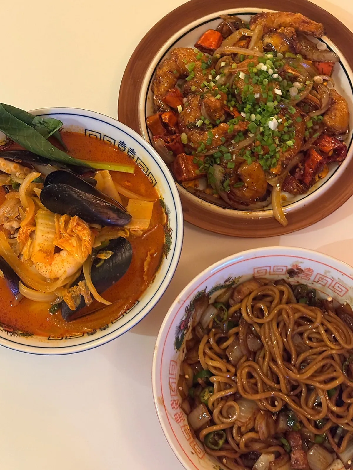 Full spread of chili jjajang, seafood jjamppong, and kkanpung shrimp