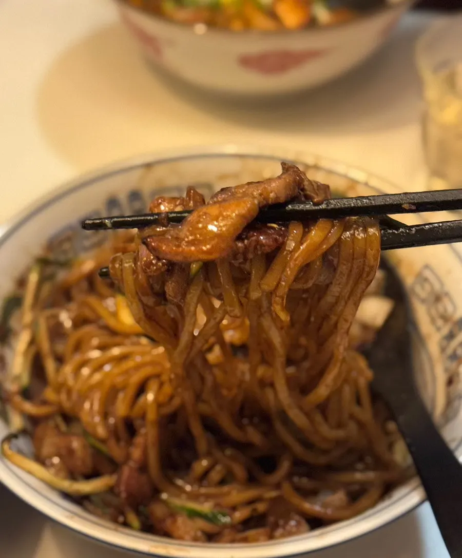 Gan-jjajang topped with pork belly and a poached egg