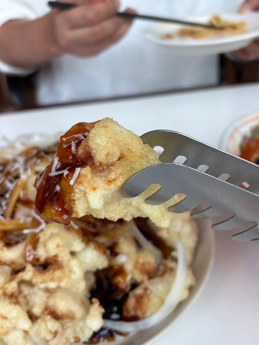 A crispy-fried piece of sweet and sour pork