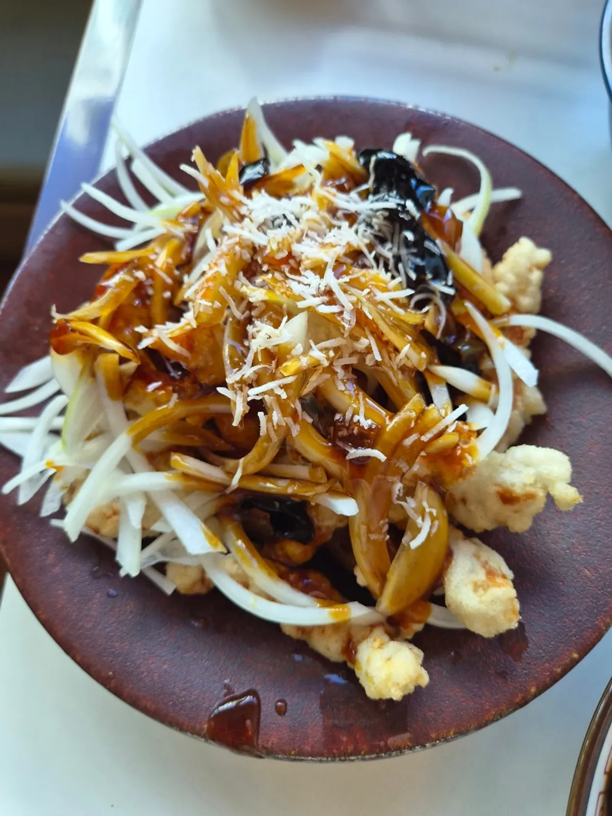 Black vinegar tenderloin tangsuyuk piled with shredded onion