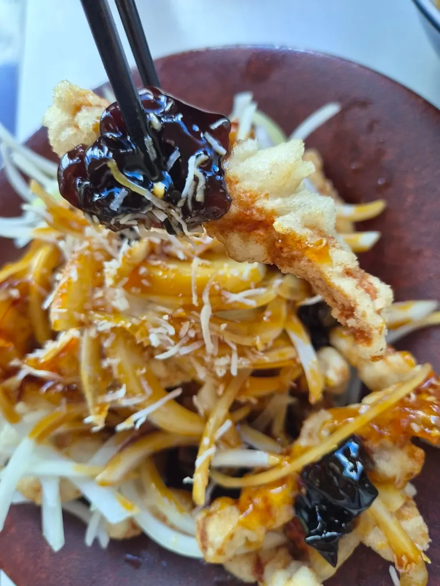 A piece of tangsuyuk with black vinegar sauce