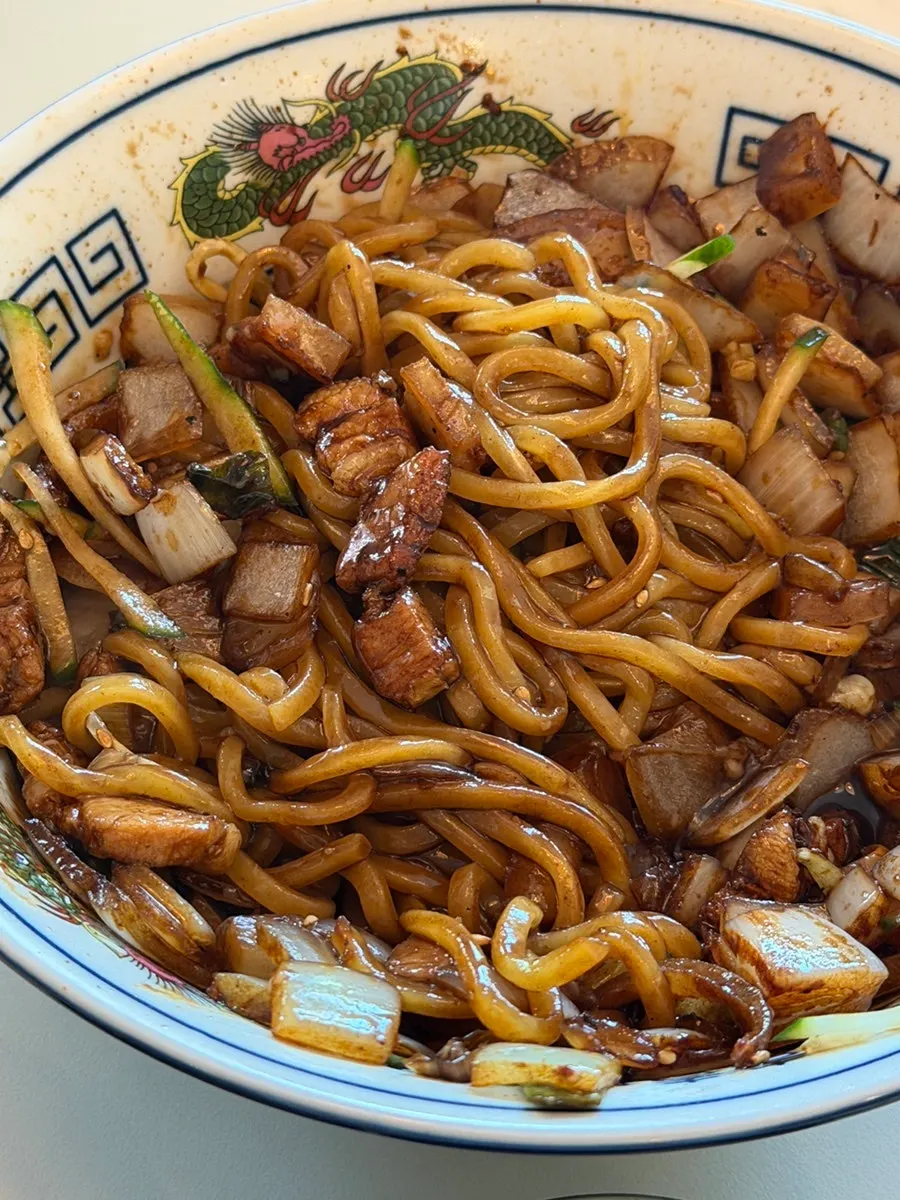 Fatty pork jjajangmyeon topped with a poached egg