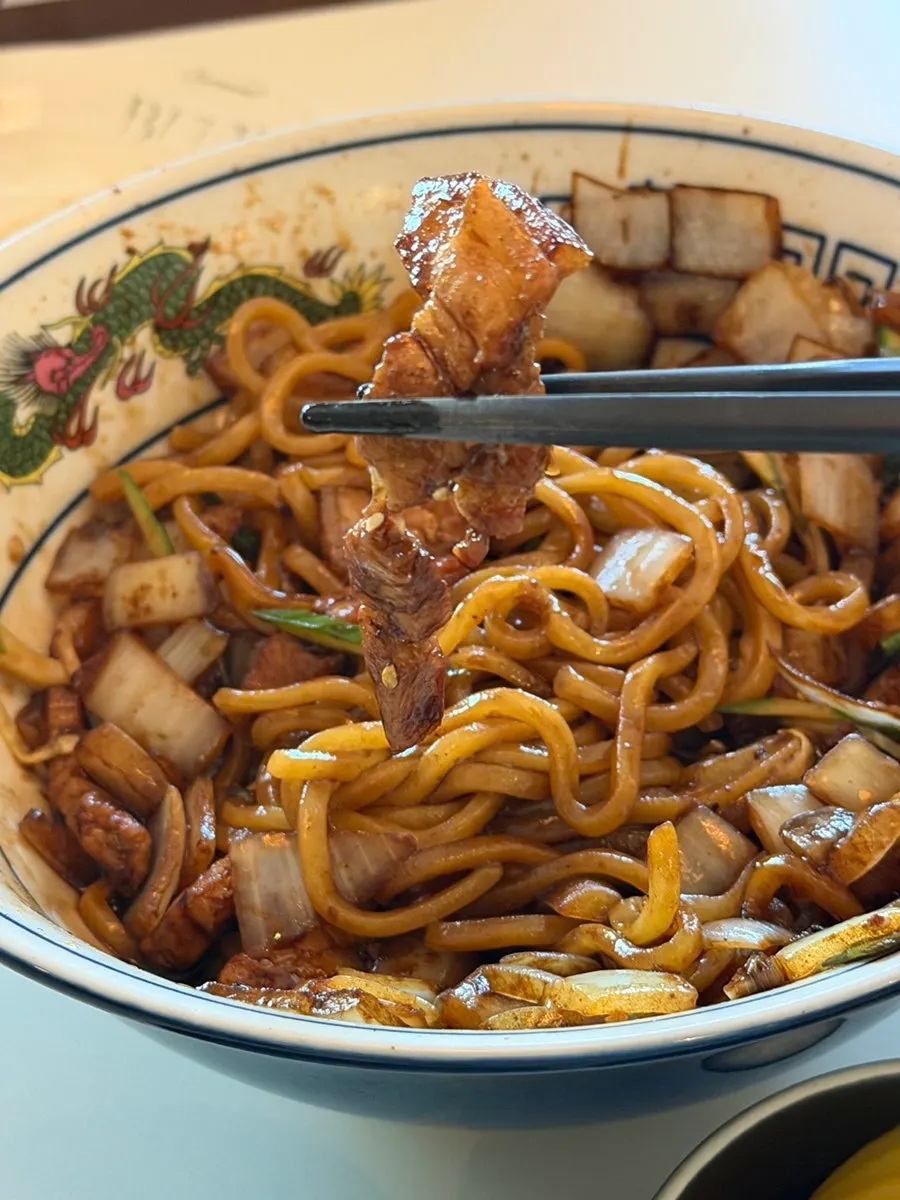Jjajang sauce mixed with the poached egg