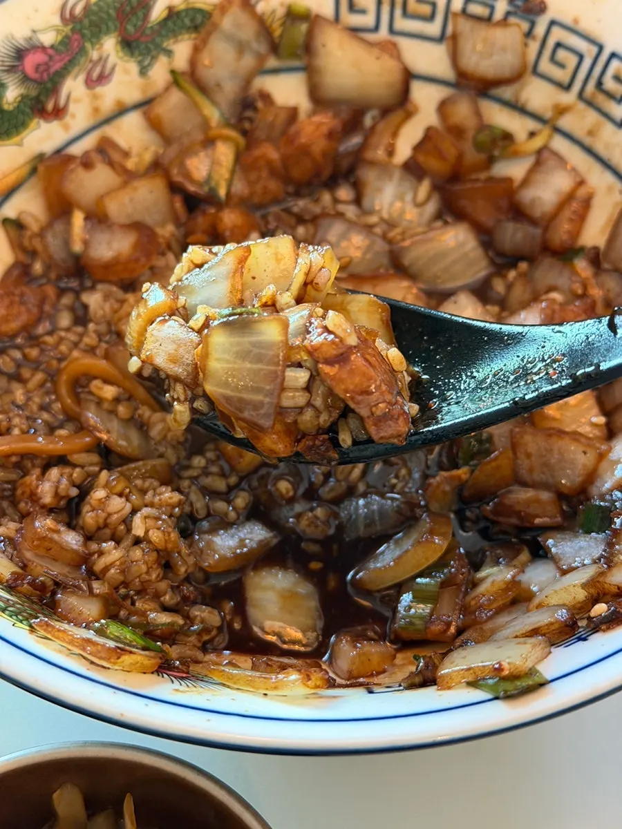 Close-up of noodles mixed into the jjajang sauce