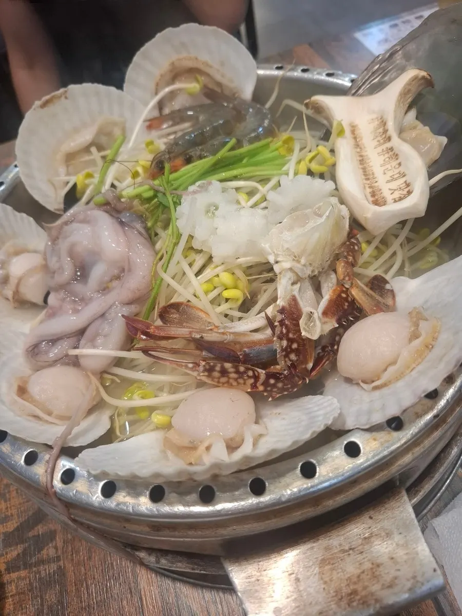Seasoned san gomjangeo sizzling on the hot plate