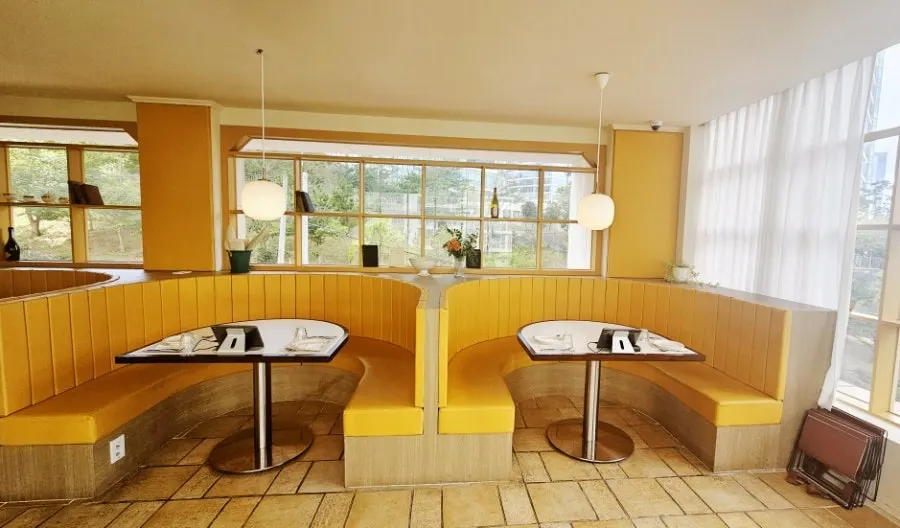 Semicircular table seating backed against the window