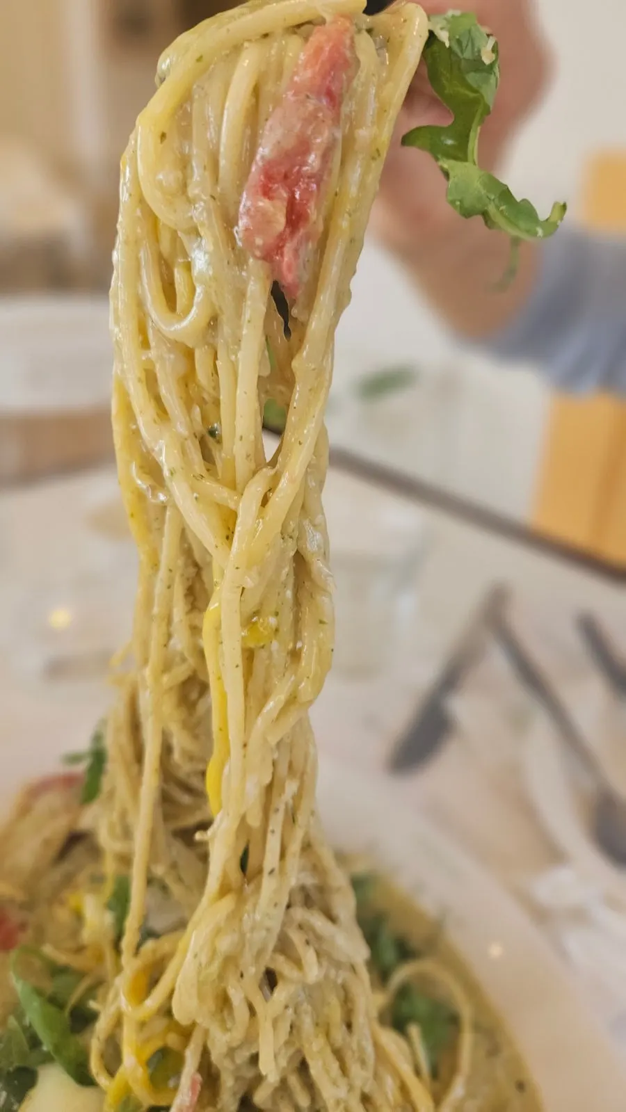Basil pesto cream pasta with a poached egg inside