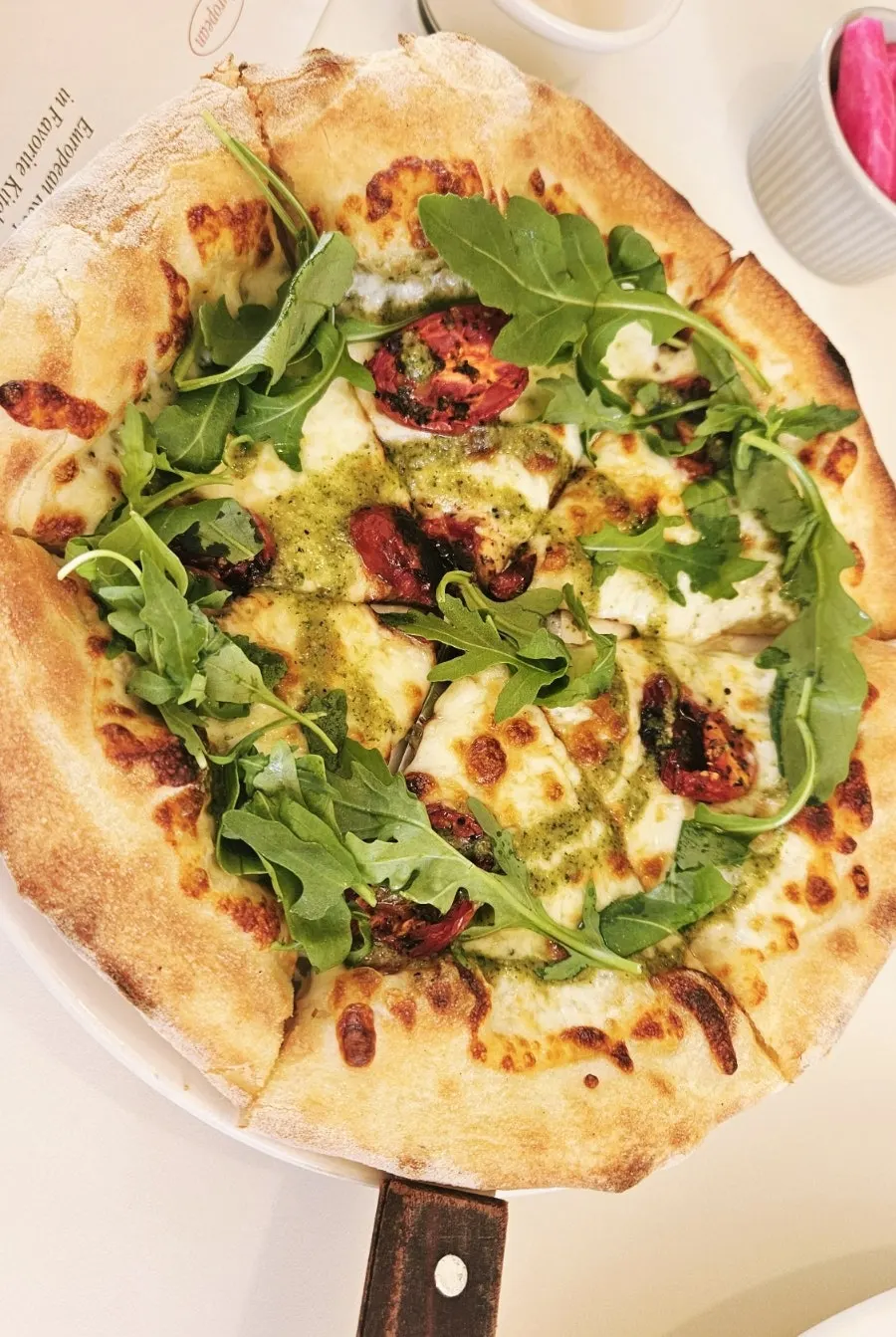 Pepperoni pizza piled high with arugula
