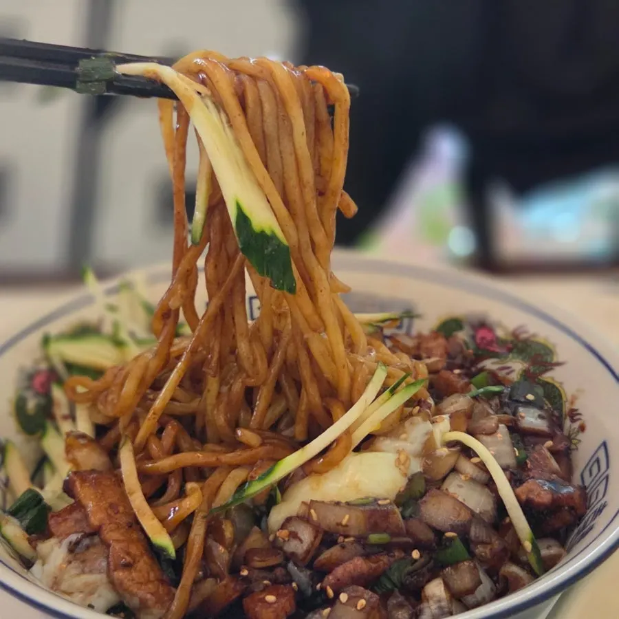 Jjajangmyeon noodles topped with cucumber and sauce