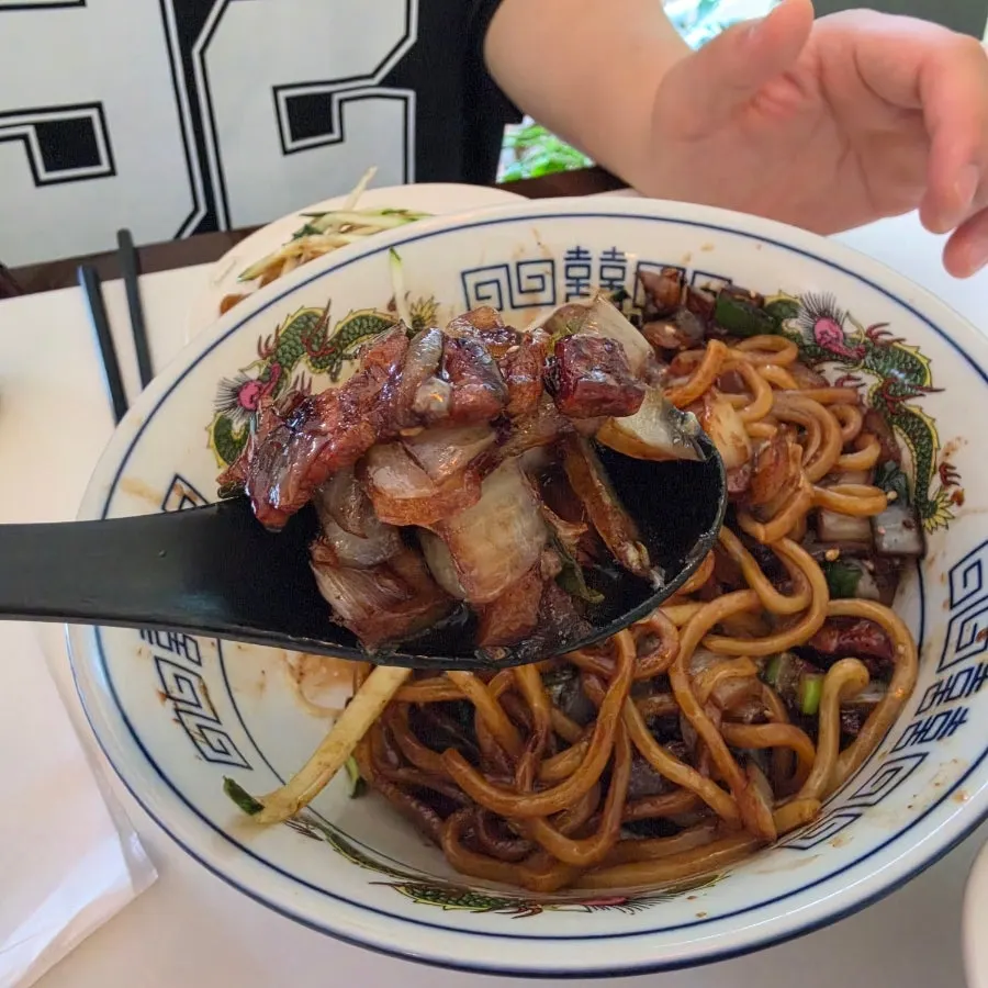 Pork belly jjajangmyeon mixed with popped poached egg