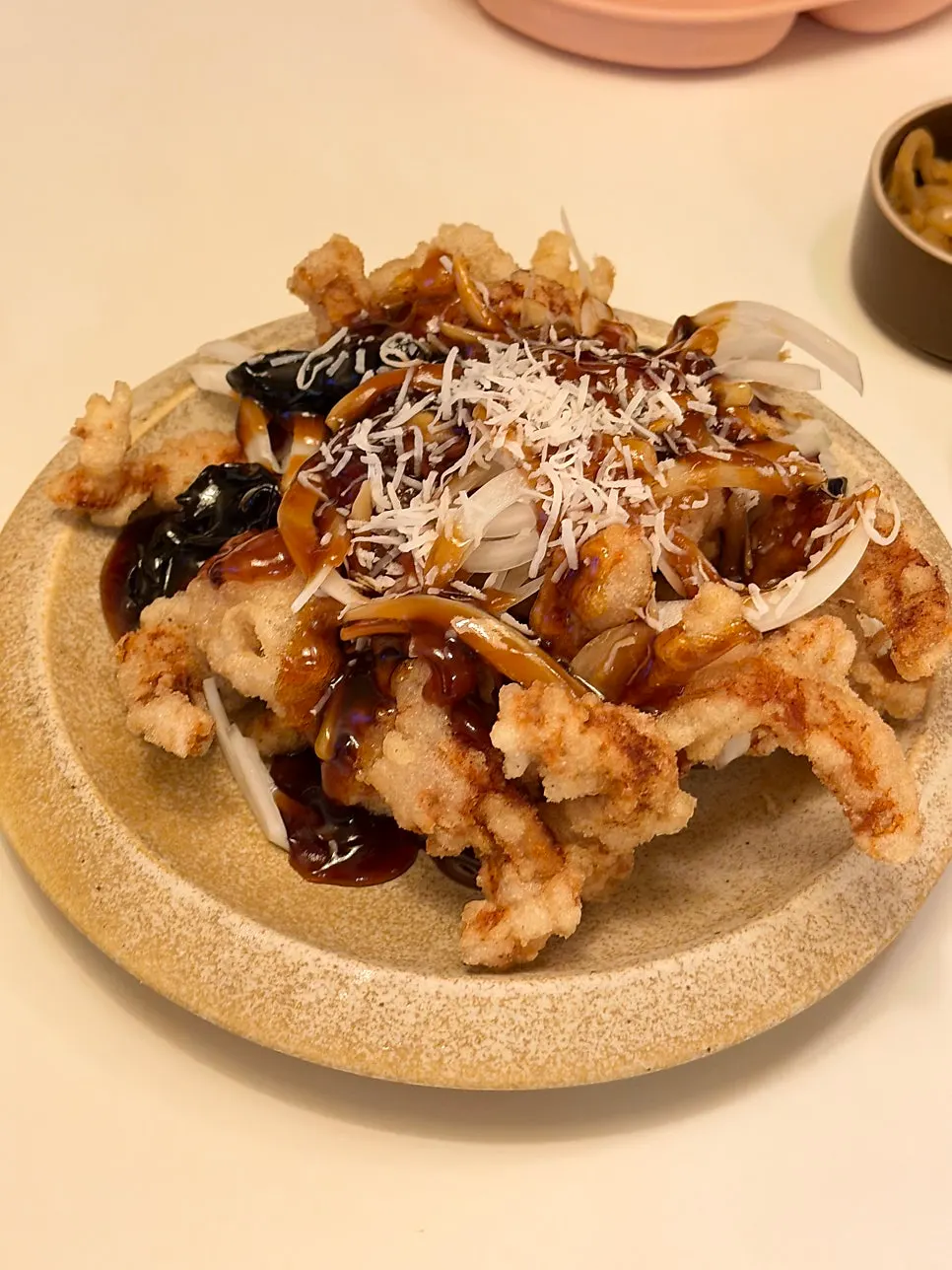 Black vinegar sweet and sour pork topped with cheese and onion