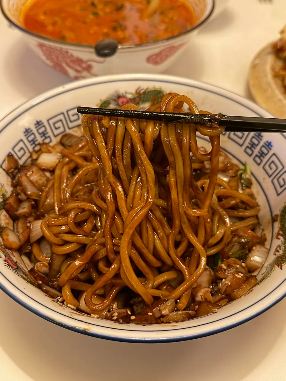 Jjajangmyeon topped with poached egg and pork belly