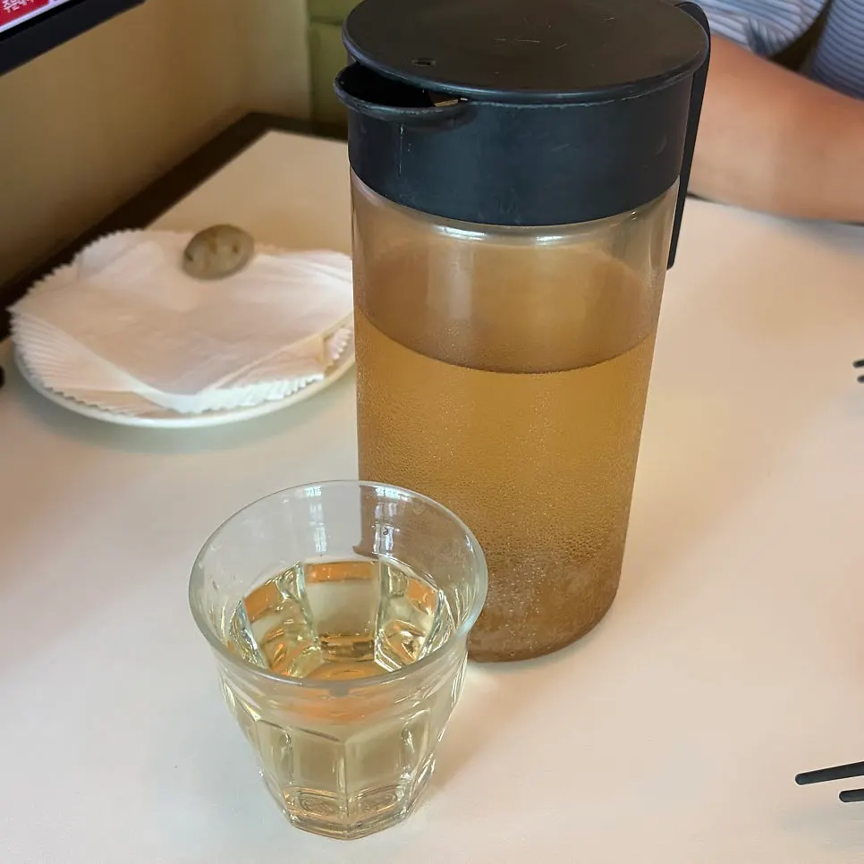 Pickled radish, jjajangmyeon pickles, and chilled herbal tea