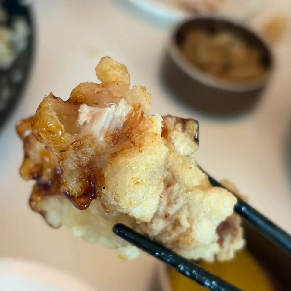 A crispy-outside piece of black vinegar sweet and sour pork