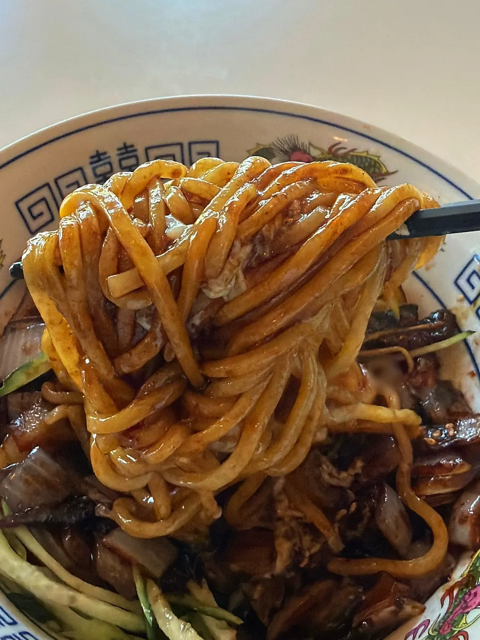 Jjajang noodles with the poached egg yolk broken open