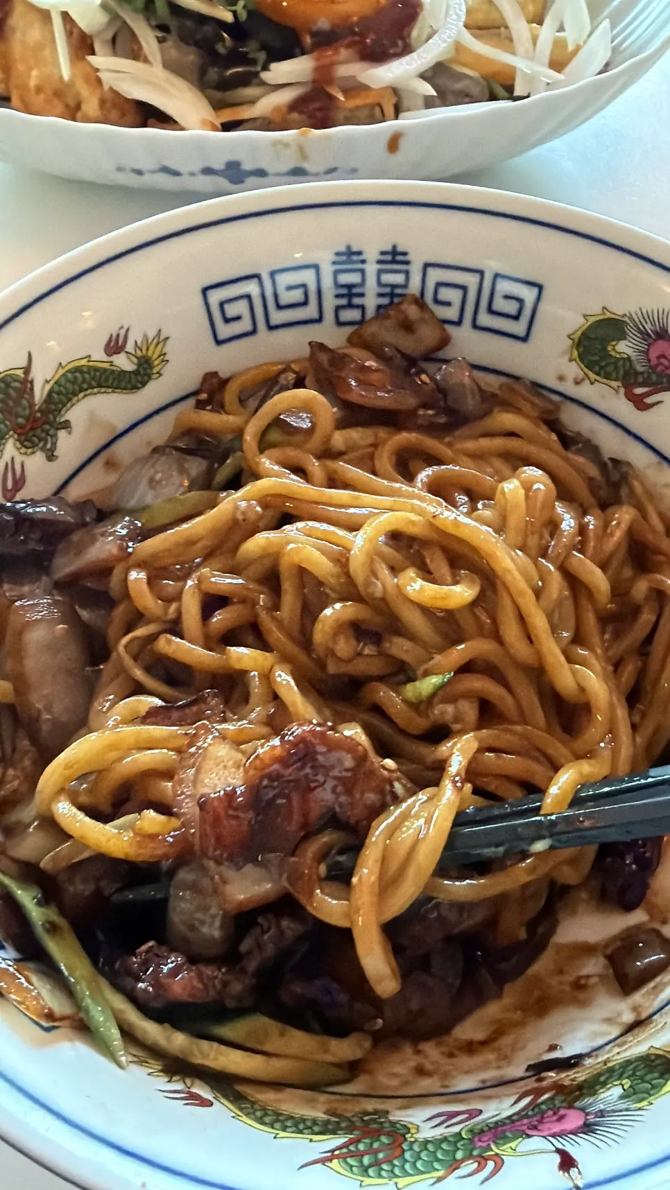 Jjajang noodles lifted up with chopsticks