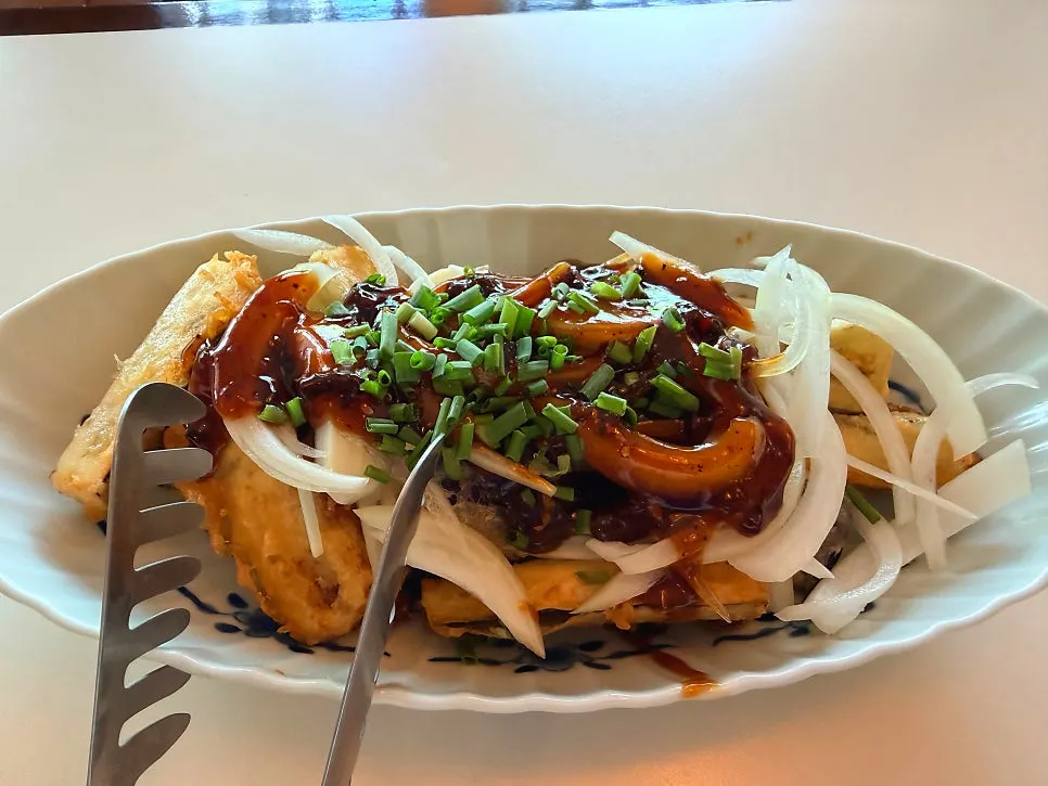 Pork belly pieces pulled up from beneath the noodles