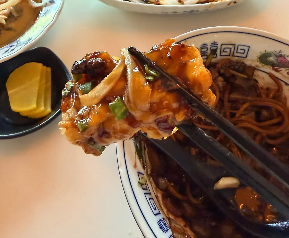 A piece of yuxiang eggplant picked up with chopsticks