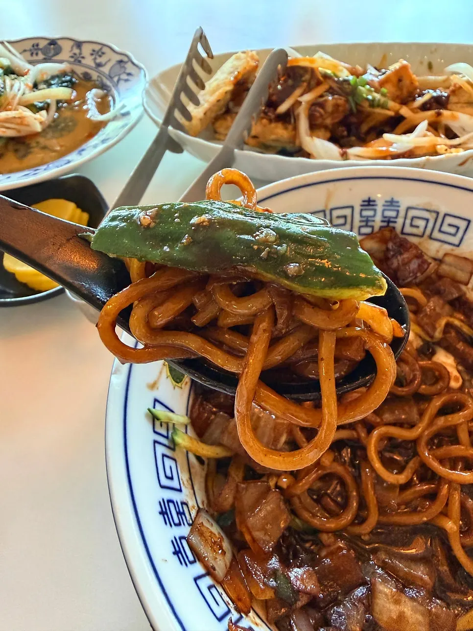 Cucumber from the paihuanggua placed on top of jjajangmyeon