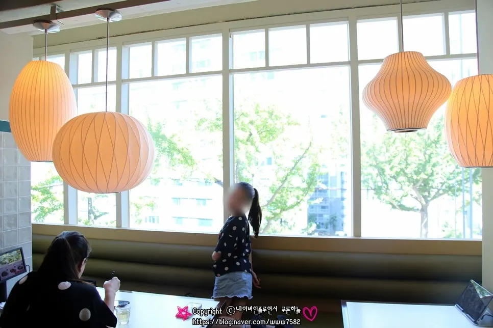 Dining hall with large windows and paper pendant lights