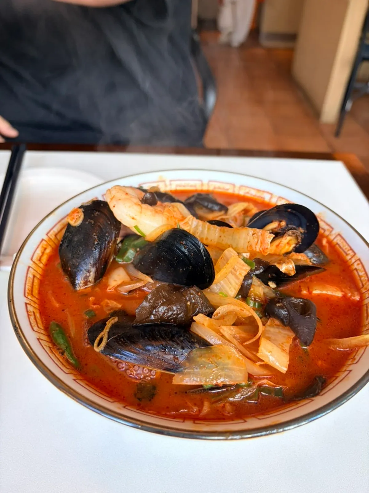 A bowl of Bueokgan Chinese jjamppong with rich red broth