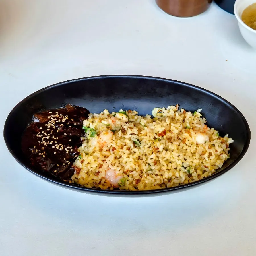 Noodles from the mala cilantro jjamppong lifted with chopsticks