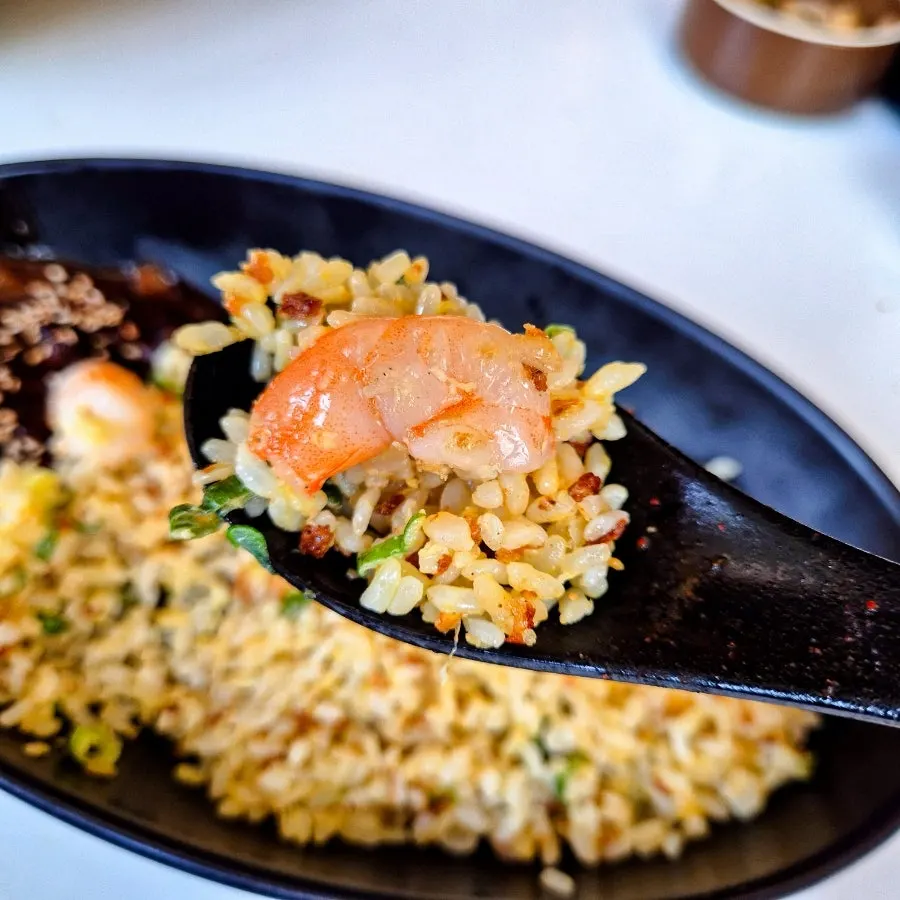 A spoonful of shrimp fried rice paired with jjajang sauce