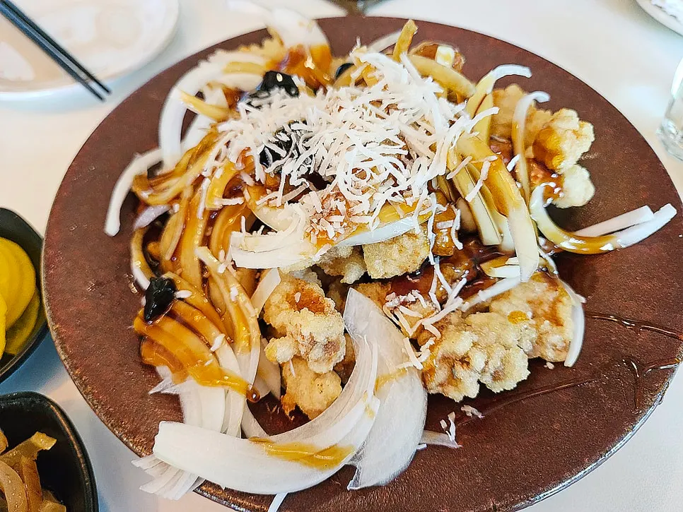 Close-up of sweet and sour pork covered in black vinegar sauce