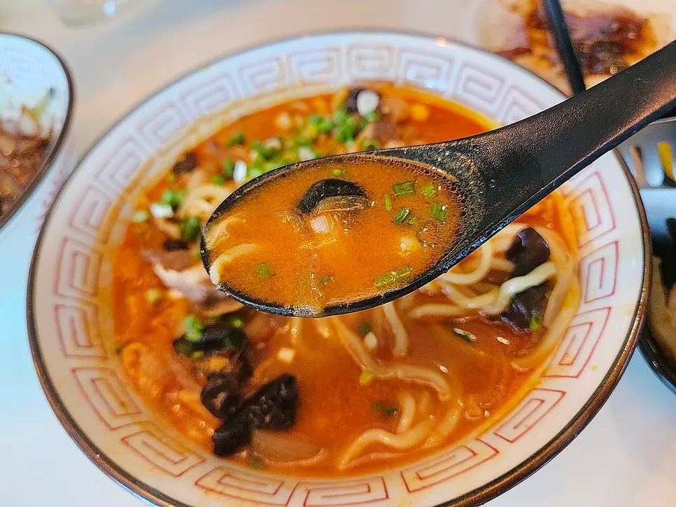 A full spread of sweet and sour pork and noodle dishes for two