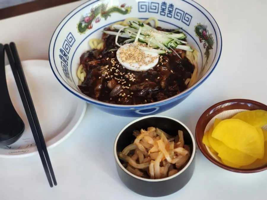 Ordered spread of jjajangmyeon, black vinegar pork, and mala coriander jjamppong