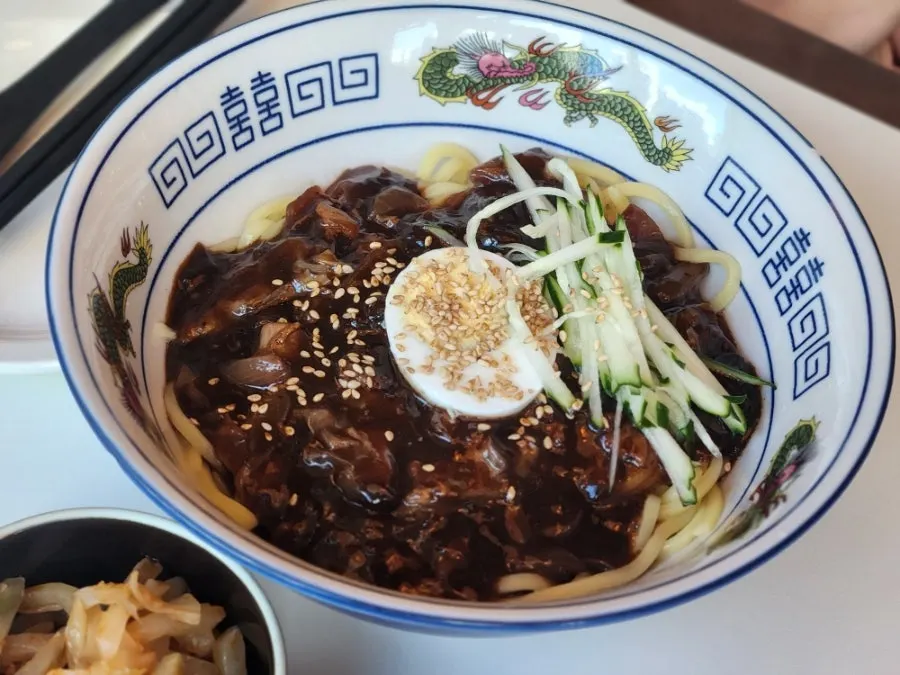 Menu items using poached egg, black vinegar, mala, and coriander