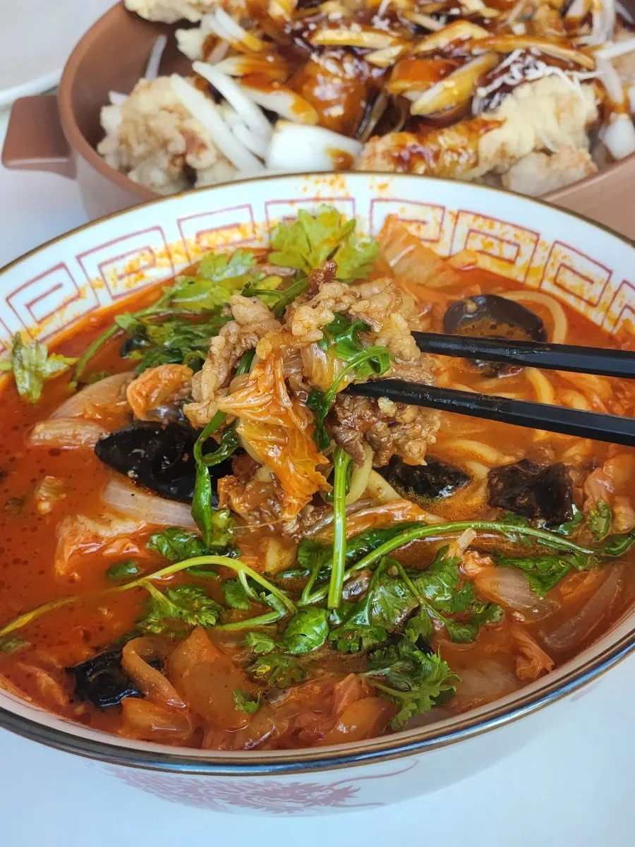 Broth of the mala jjamppong topped with coriander