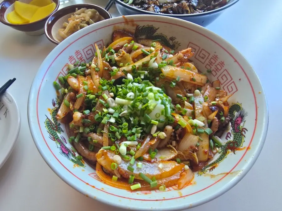 Bowl of pork belly jjajangmyeon topped with poached egg