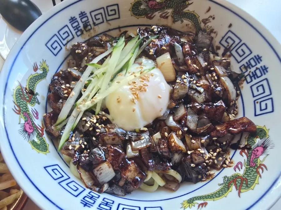 Close-up of thick pork belly on jjajangmyeon