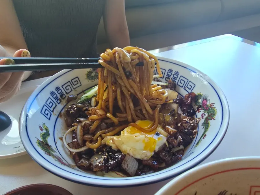 Pork belly jjajang mixed with burst poached egg