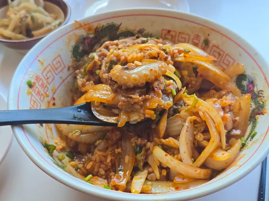 Octopus and poached egg mixed into the rice bowl