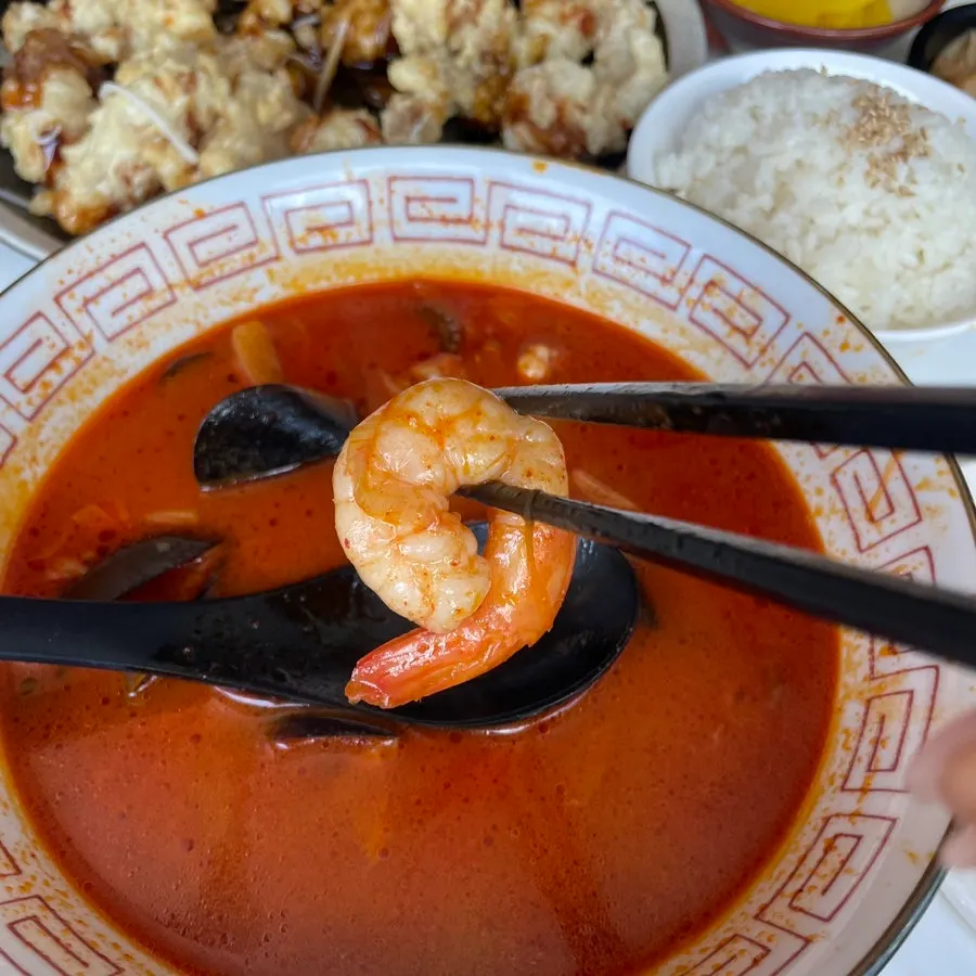 A spoonful of seafood scooped from the jjamppong