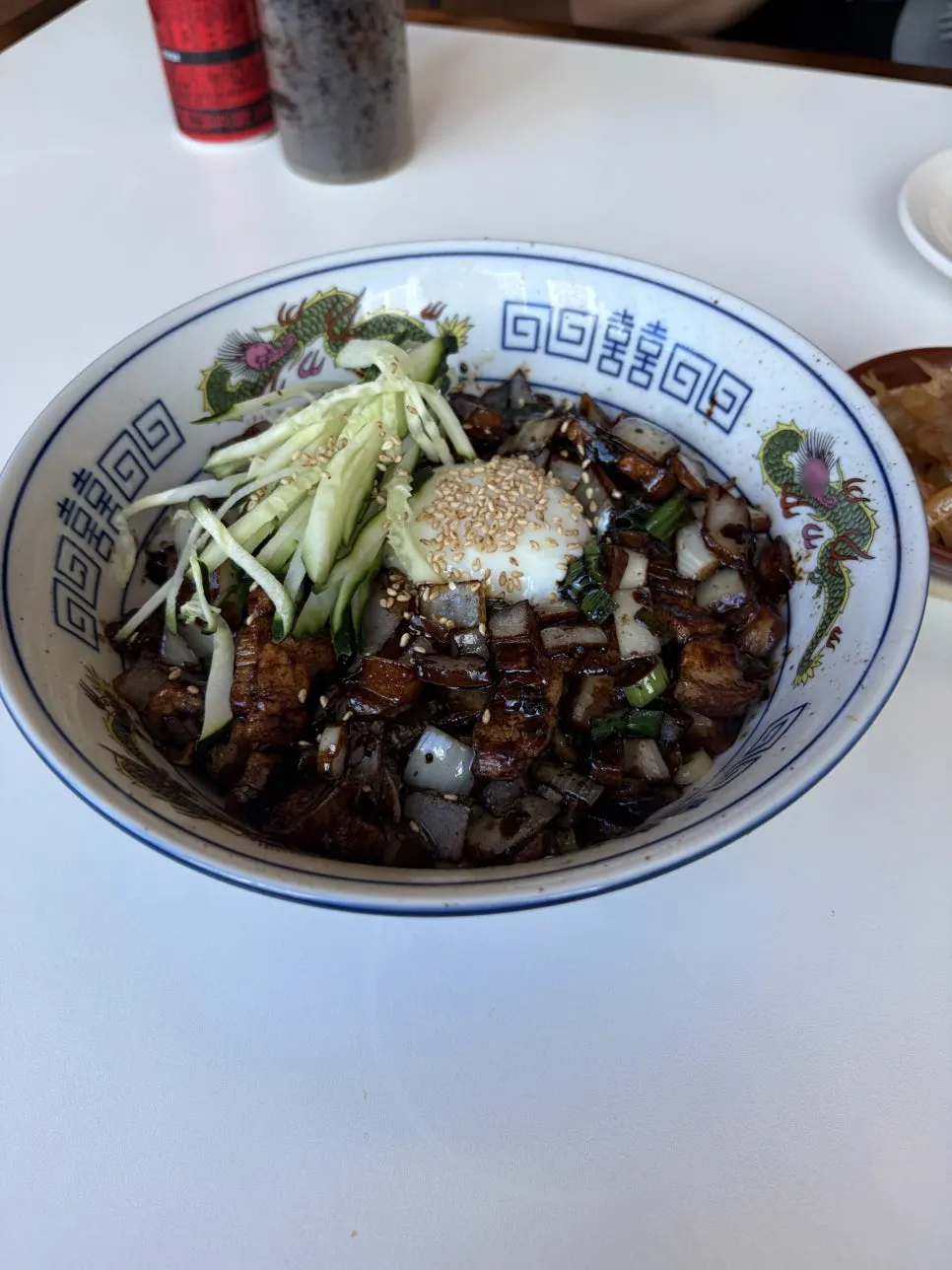 Close-up of five-layer pork jjajangmyeon topped with poached egg