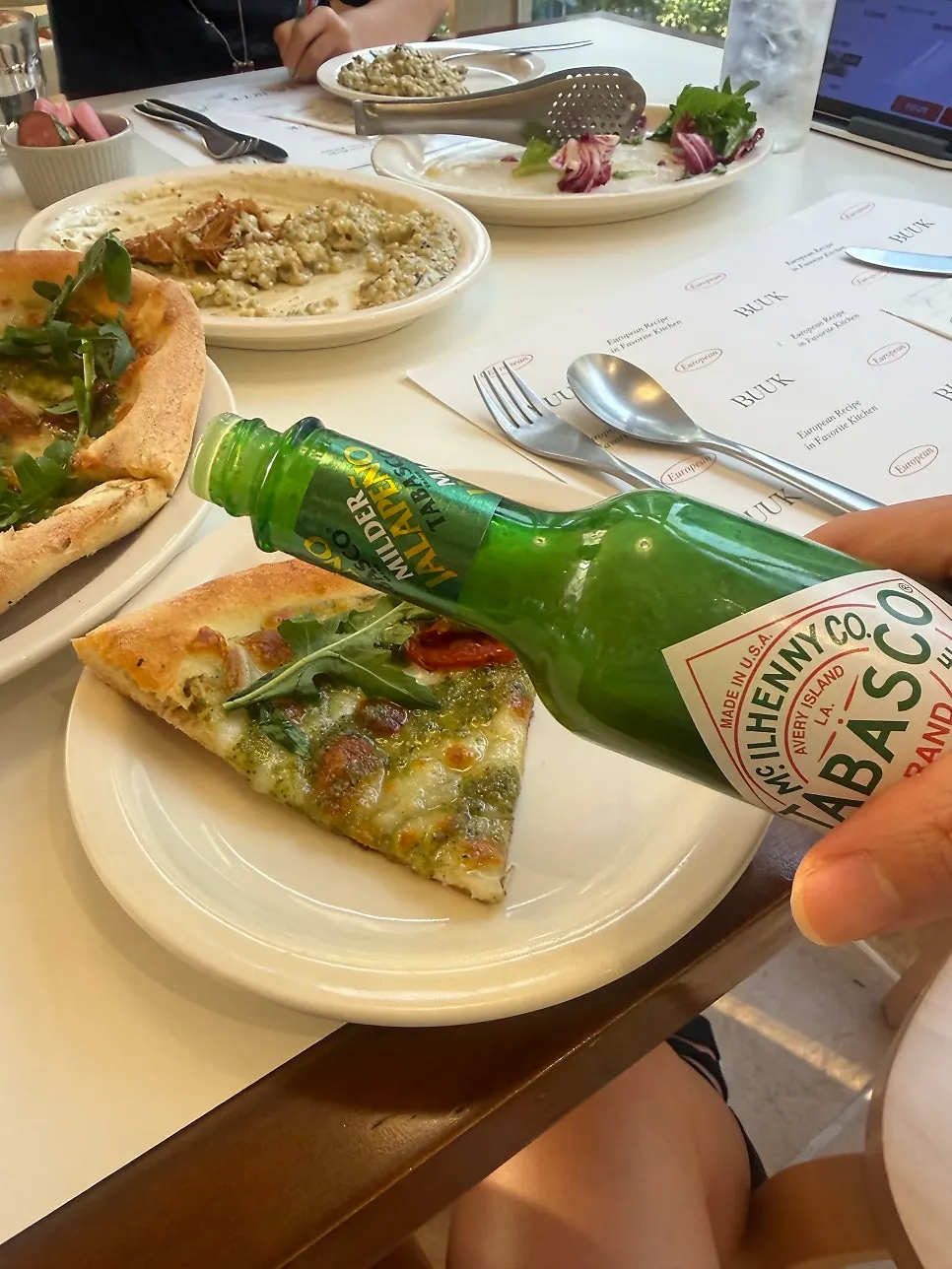 A slice of basil margherita pizza