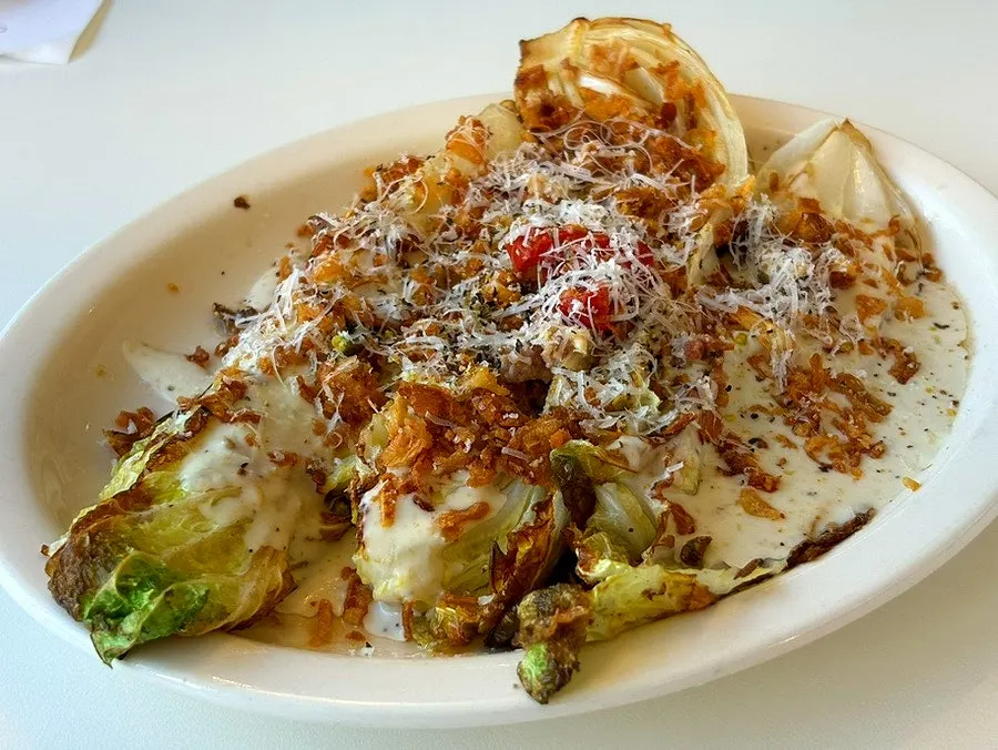 Close-up of thick bacon and fried onion flake topping