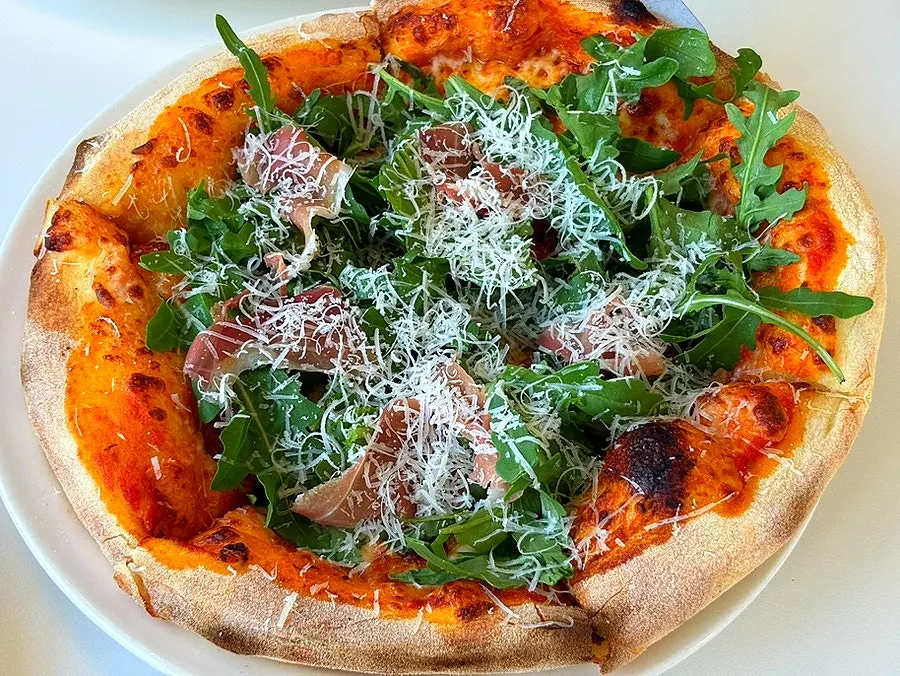 A whole arugula prosciutto pizza